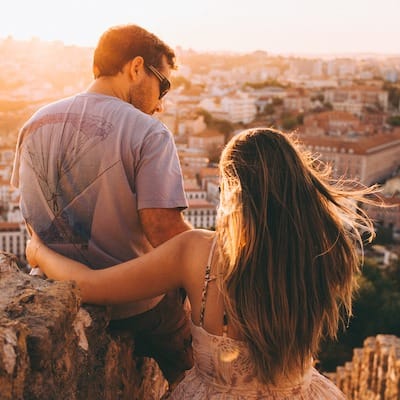 Couple amoureux qui regarde dans la même direction sur les hauteurs de la ville